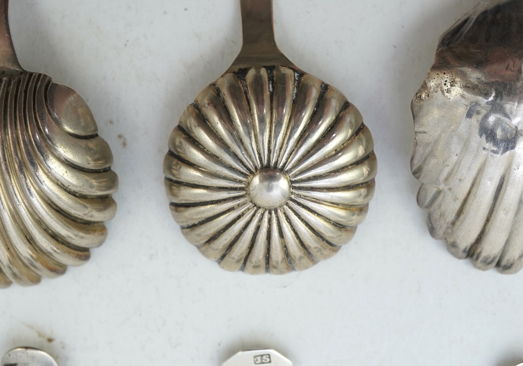 Ten assorted mainly 19th century silver and white metal caddy spoons, with shell or fluted bowls